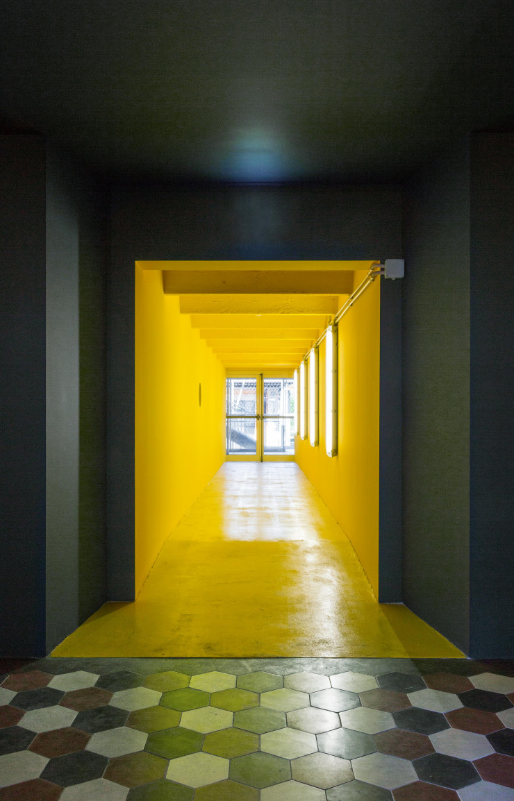 Le jaune vif du couloir contraste avec la partie hôtel, marquant le changement d’univers, le passage vers les autres espaces du bâtiment.