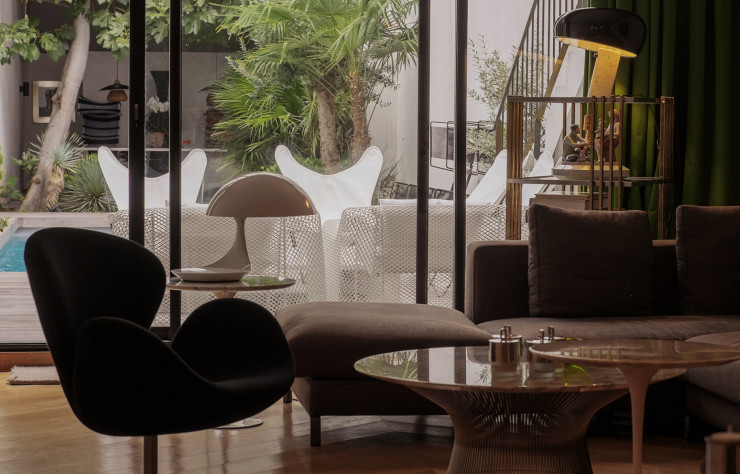 Entre la lampe « Snoopy » d’Achille et Pier Giacomo Castiglioni, le fauteuil « Swan » d’ Arne Jacobsen et les tables de Warren Platner et Eero Saarinen, de grands noms du design se croisent dans le salon.