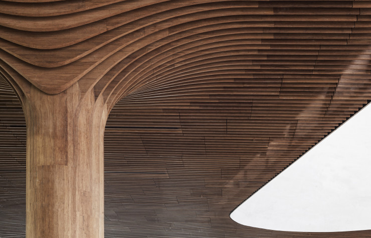 A l’intérieur de la galerie commerciale, les courbes caractéristiques du travail de Zaha Hadid s’appliquent au revêtement en bambou.